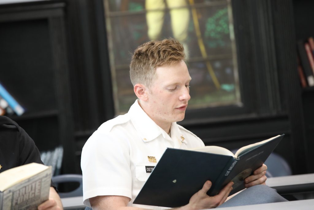 College cadet reading a book