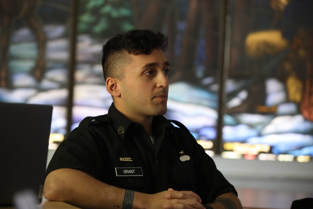 College cadet in front of stain glass window